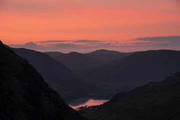 Stunning colorful landscape image of view down Honister Pass to Buttermere from Dale Head in Lake District during Autumn sunset