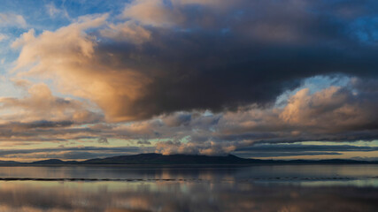 Beautiful sunset landscape image of Solway Firth viewed from Silloth during stunning Autumn sunset with dramatic sky and cloud formations