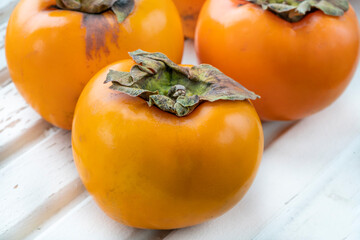 closeup ripe persimmon  fruits on table