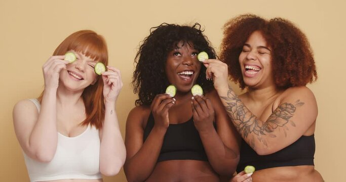 Multiracial group of women do eye masks with cucumbers