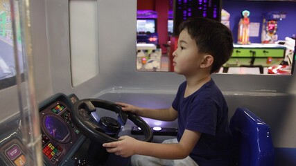 Preschooler playing on amusement park and slot machines