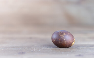 One painted egg is lying on the table