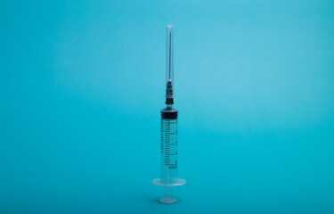 A syringe with a vaccine on background