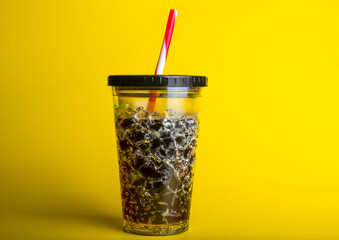 Glass of frozen cocktail with cola background.