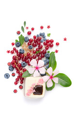 A scattering of juicy berries, flowers and a soufflй cake.