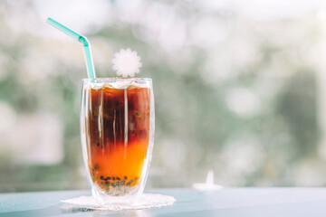 fusion drink menu Black coffee with passion fruit, blurry background