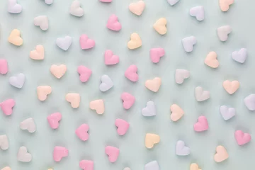 Poster Composition with candy hearts on pastel blue background. © gitusik