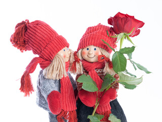 Dolls, a boy and a girl with flowers, make congratulations.On a white background .Concept .Postcard for Valentine's Day, Friend's Day, February 14, mother's day