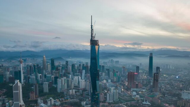 4k time lapse of sunrise at Kuala Lumpur city skyline, aerial drone view. Zoom out