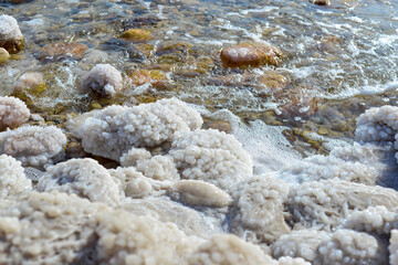 Close up of salt background. Natural salt. Dead Sea salt mineral natural formations. Salt crystals from Dead sea. View of Dead Sea coastline. Texture of Dead sea. Salty seashore rocks