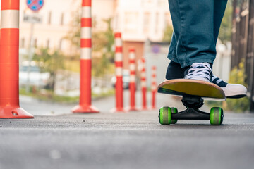 Legs of a man on a skateboard on the street