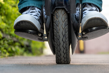 the rider's legs on an electric unicycle (EUC) © Alex Images