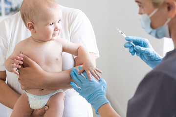 Pediatrician makes vaccination to small boy - obrazy, fototapety, plakaty
