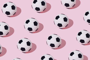 Soccer balls on pastel pink background. Minimal soccer ball pattern. Football mood. Football minimal concept. Sport days. Flat lay.