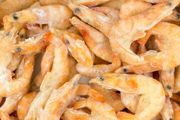 Fresh, raw shrimps on ice. Frozen product for cooking.