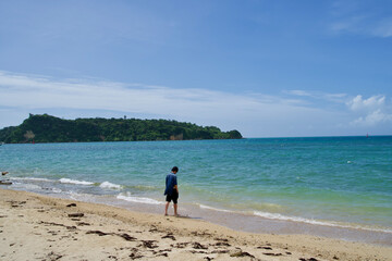 A man standing on the beach in Okinawa.