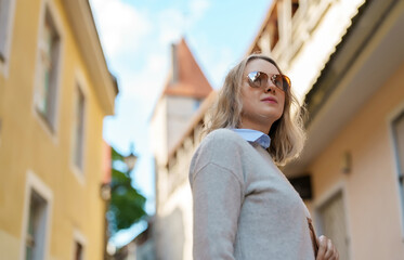Female tourist in sunglasses in old Tallinn.