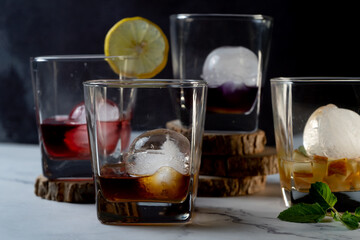 multiple whiskey glasses filled with different colored infused mulled wine gin rum vodka drinks...