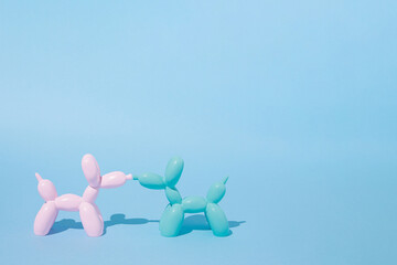 Two balloon dogs in love on pastel blue background. Love card. Layout. Flat design. Minimal valentines concept. Couple. Birthday party mood.