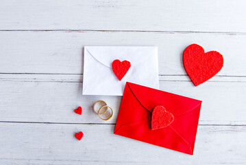 Valentine's day concept, love letter and wedding rings on wooden table.
