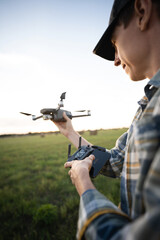 Fototapeta premium Farmer with drone on a field. Smart farming and precision agriculture
