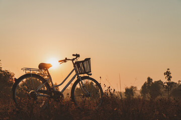 Fototapeta na wymiar Landscape of vintage bicycle at sunrise. For making gift pictures, postcards. morning exercise by bike.