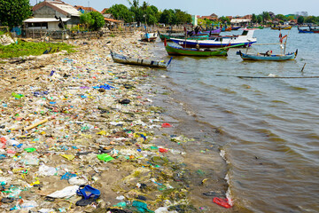 Garbage litters the beach which mostly consists of plastic waste. Scenes like this are common on...