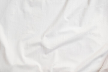 Closeup rippled soft white fabric texture background.