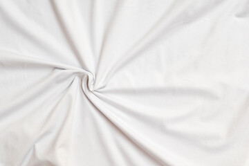 Closeup rippled soft white fabric texture background.