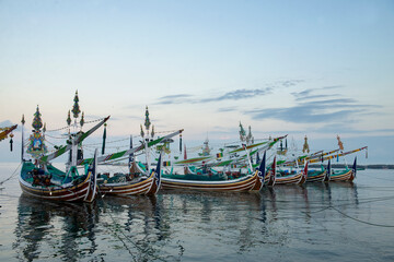 Naklejka na ściany i meble Traditional fishing boats at Pengambengan fishing port in Bali Island, Indonesia.
