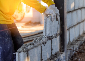 Bricklayer putting down another row of brick
