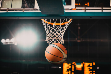 Basketball going through the hoop at a sports arena