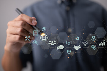 IoT, digital marketing, and global business. Business strategy concept for the Internet of Things. With technical icons, a businessman touches on the worldwide network.