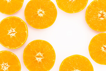 Juicy slices of orange or tangerine on light background. Colorful creative background with copy space. Top view