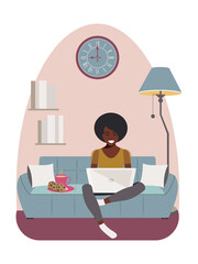 An African American woman sits on a comfortable blue sofa and works with a laptop at home during quarantine due to the coronavirus. Modern concept of distance learning online. 