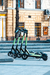 rental electric kick scooter parked at city street