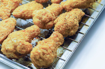 Southern crispy battered fried chicken wings, deep-fried chicken wings on the metal tray
