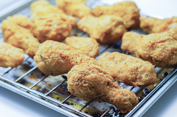 Southern crispy battered fried chicken wings, deep-fried chicken wings on the metal tray