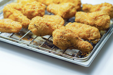 Southern crispy battered fried chicken wings, deep-fried chicken wings on the metal tray