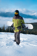 man snowboarder portrait carpathian mountains on background