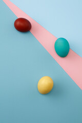 Colorful Easter eggs on blue and pink background