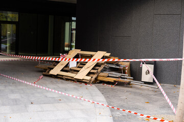 Red lanterns and a protective tape at the road repair sector. Compliance with safety measures at...