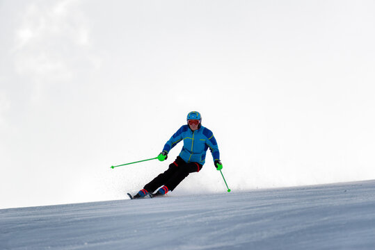 Skier Skiing Downhill On Slope