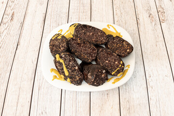 Burgos blood sausage is a sausage based on pork blood typical of Burgos gastronomy. To the ingredients are added onion, lard, salt, pepper, paprika, oregano, and other spices