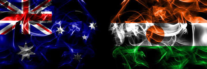 Flags of Australia, Australian vs Niger, Nigerien. Smoke flag placed side by side on black background