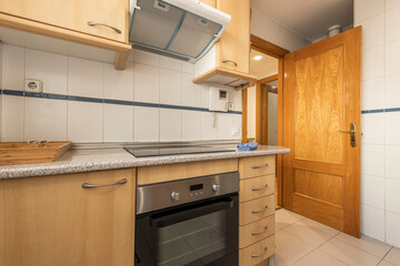 Kitchen with beech wood furniture in vacation rental apartment