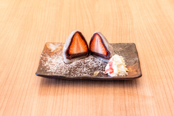 In Japan, sticky rice is known as mochigome. It is used as an ingredient in the preparation of mochi, a rice cake, this one with strawberries and cream.