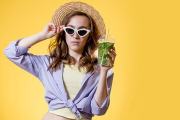 Summer refreshment. Cold beverage. Happy woman in sunglasses holding plastic glass of mojito. Non-alcoholic drink. Detox lemonade