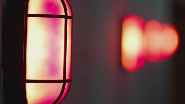 Many warning alert blinking lamps and danger attention sign on the concrete wall . Signalization , alarm , safety , security concept . Close up Shot on ARRI ALEXA Cinema Camera in Slow Motion .