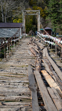 Wooden suspension bridge over the river Bzyb in the Caucasus mountains in Abkhazia.